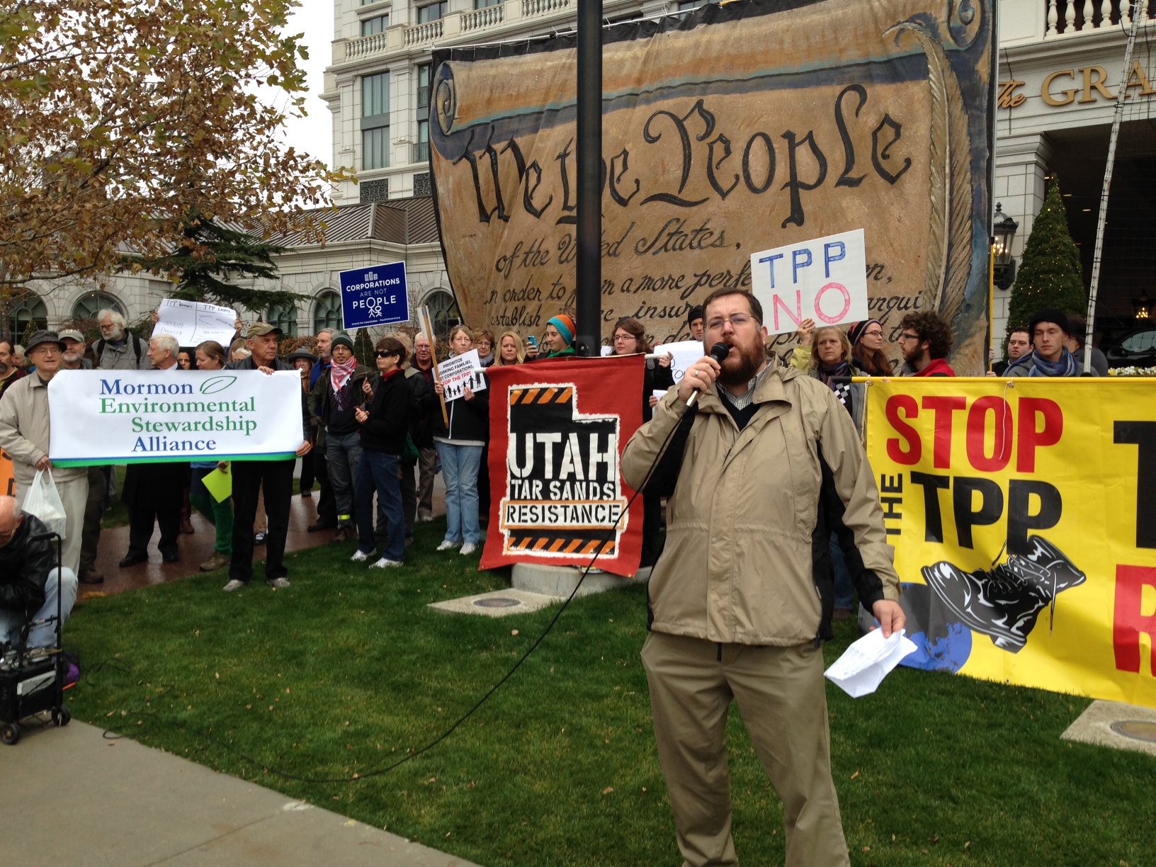 Citizens Trade Campaign Executive Director Arthur Stamoulis speaks to demonstrators outside the Grand America Hotel in downtown Salt Lake City on Tuesday.