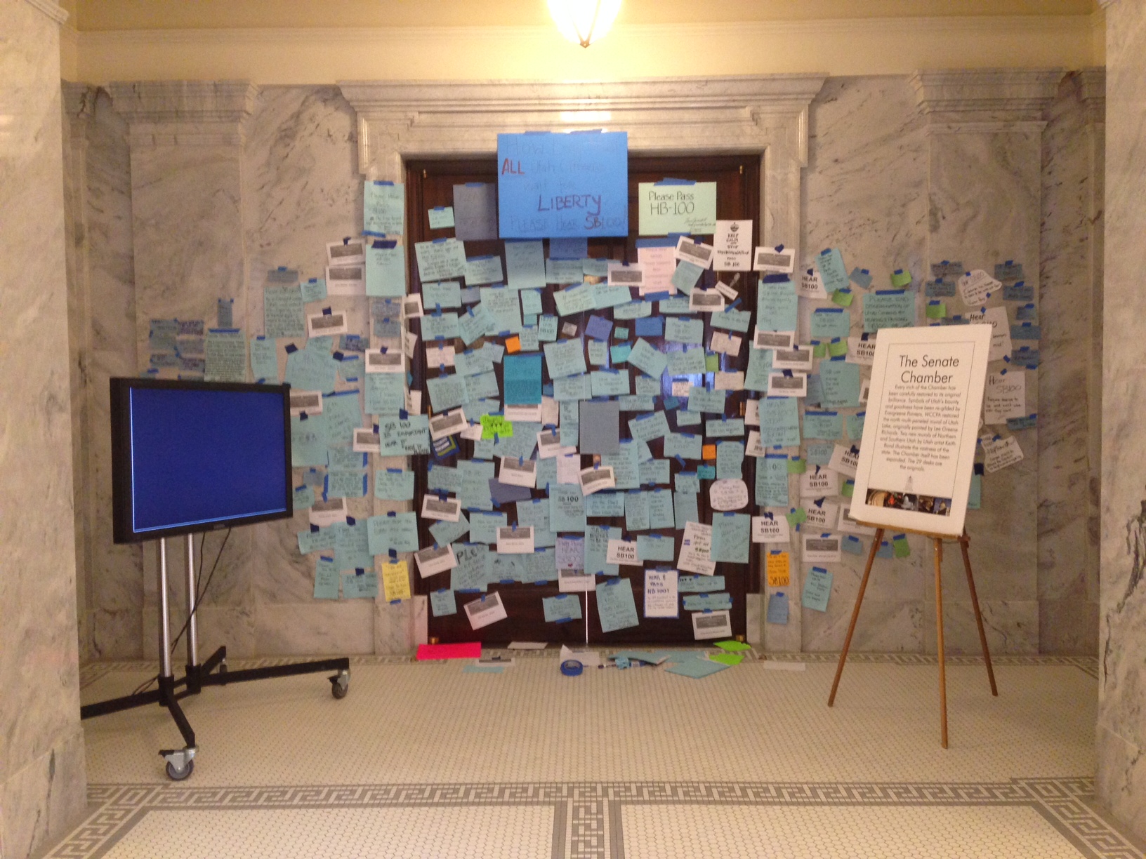 The main doors to the Utah Senate Chamber are covered in notes from supporters of SB 100, a bill that would make it illegal to discriminate against LGBT individuals in employment and housing in most cases.