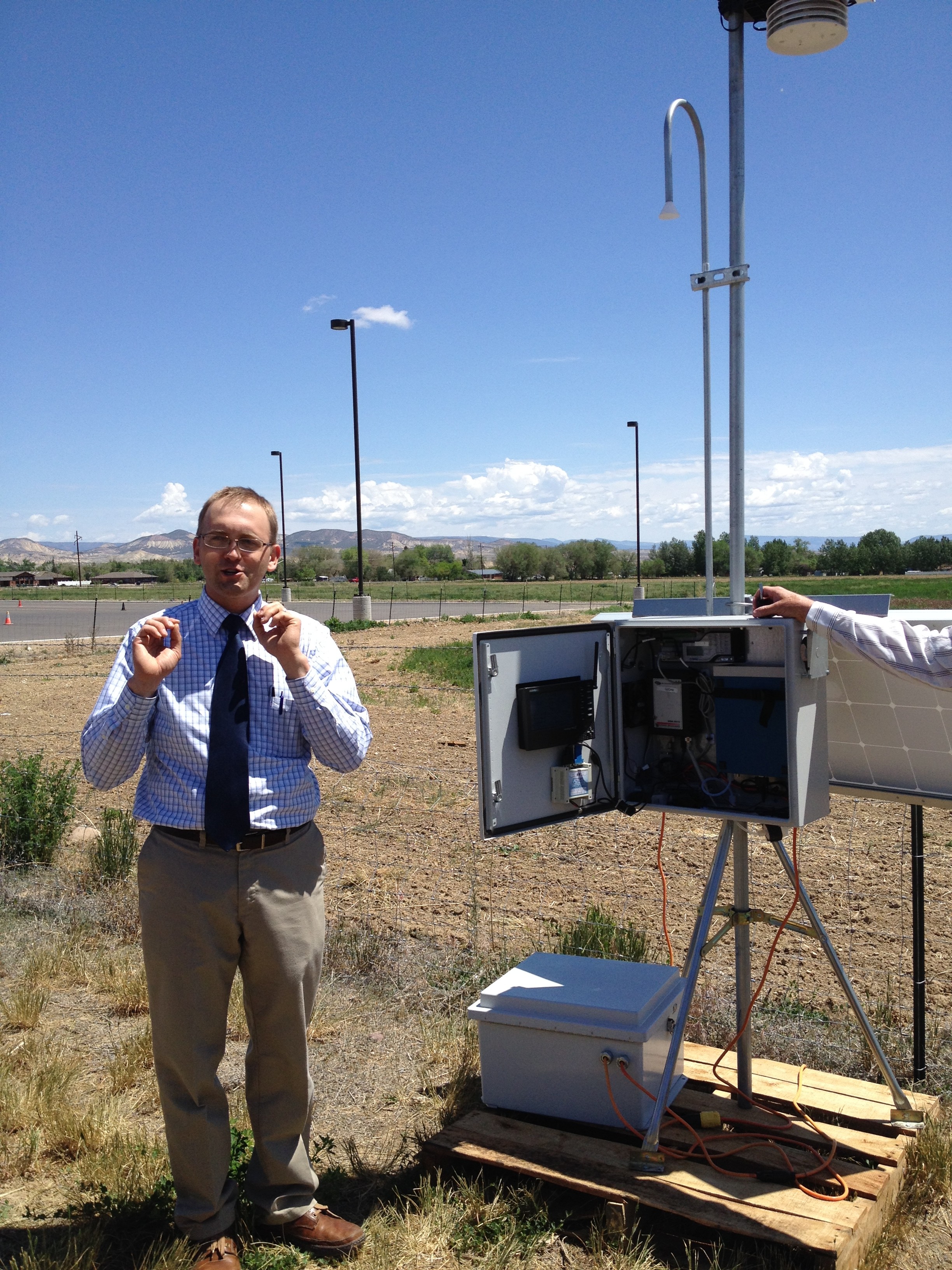 Utah State University researcher Seth Lyman stands next to an ozone monitor at the Bingham Research Center in Vernal.