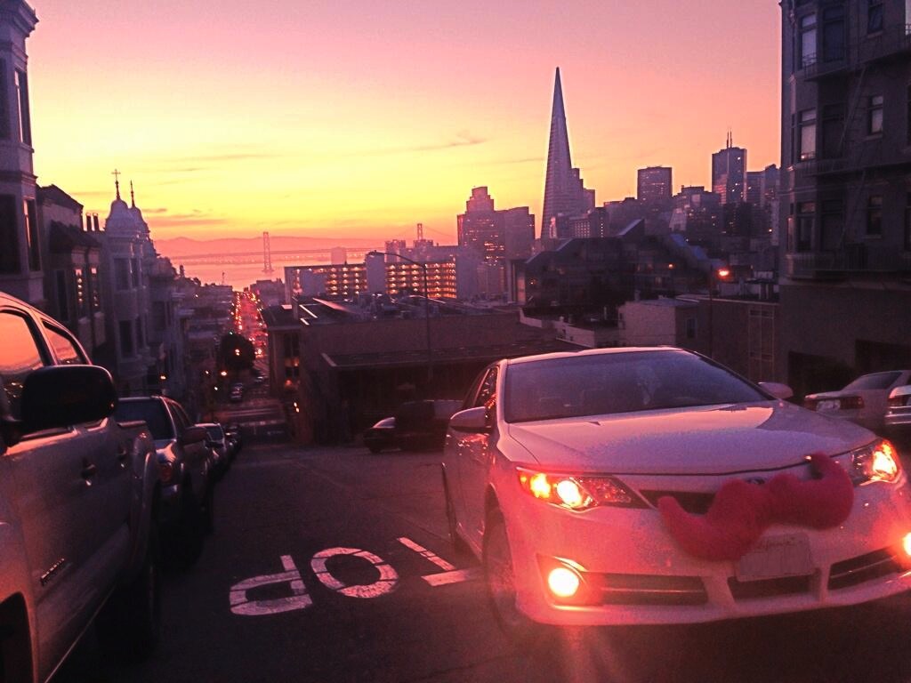 A car in San Francisco with the trademark pink Lyft mustache.